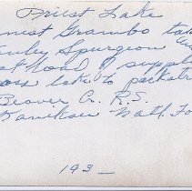 Grambo and Spurgeon taking supplies across the lake to a packtrain - circa 