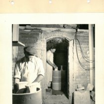 Kilns, George Brunt (foreground) and William Withroe (background) loading the kiln with bisqueware.