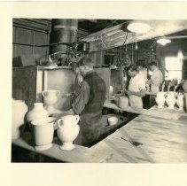 Unidentified Cowan employee (foreground), George Brunt (center), Ray Todd (background) working at the Studio’s spray booths.