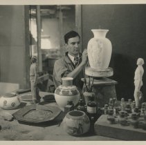 Cowan employee Paul Josef Bogatay hand painting a vase.