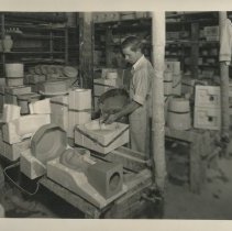Cowan employee George Brunt pouring slip into a plaster mold.