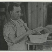 Cowan employee handling slab of clay