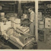 Cowan employee George Brunt pouring slip into a plaster mold.
