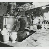 Cowan employees working at the Studio’s spray booths.