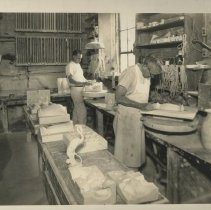 Cowan employees removing pieces from molds