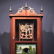 Pillar and scroll reproduction clock with visible wooden works