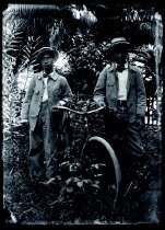 Two men with a bicycle, Kalaupapa Settlement, Molokai.