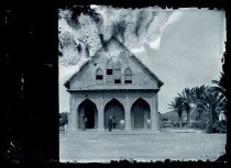 Father Maxime Andre, SS.CC. and others at front entrance of Saint Francis of Assisi Church, Kalaupapa, Molokai.