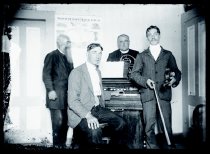 Father Maxime Andre, SS.CC., Dr. William J. Goodhue, Fr. Ulrich Taube, SS.CC., and Dr. H.T. Holman during a music session with organ, violin and French horn, Kalaupapa, Molokai, 1905-1908.