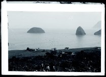Three men on hill above Kalawao, Molokai.