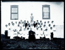 First communion recipients pose with Father Charles (Rombaut) Windels, SS.CC.