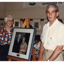 Vern and Phyllis Wellburn pose by photo of their parents