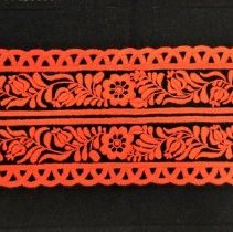 Red floss embroidery on black felt