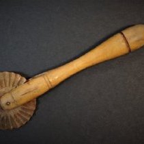Wooden baking utensil used for edging dough