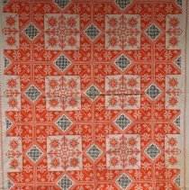Orange cross-stitch tablecloth close-up