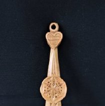 Carved wooden spatula in folk art design