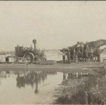 Tractor and threshing machine on ferry