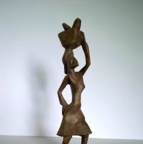 African Woman Walking with Basket on Head