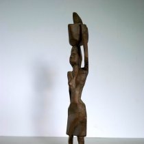 African Woman Walking with Basket on Head