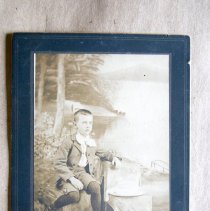 Clyde Law(?) seated against lake backdrop