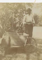John Luckett Standing Next to Wheelbarrow