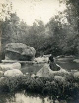 Woman Sitting on Rocks