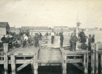 Workers with Lumber at a Dock