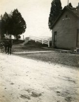 Carriage on Dirt Road Next to Public School