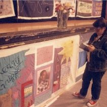 Person stands with quilt