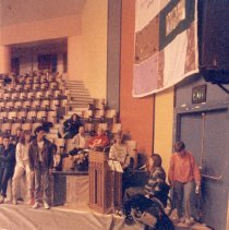 Person speaks to group at memorial