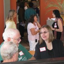 Attendees chat at reception.