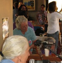 Candid of woman singing at reception.