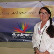 Trailblazer poses with poster.