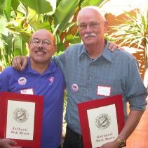 Bob Correa and Denny Carroll pose with awards.