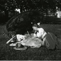 Sisters lounge with dog and parasol at Mangels house