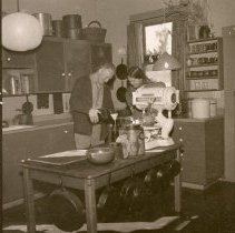 Individuals work at pottery studio.