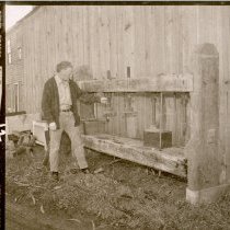 Man shows farming equipment at the ranch.