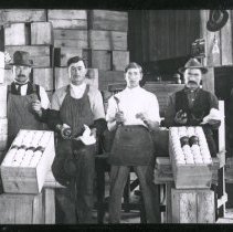 Men at work packing apples.