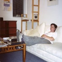 Candid of woman sitting on couch.