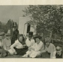 Dole, group of eight people wearing costume hats