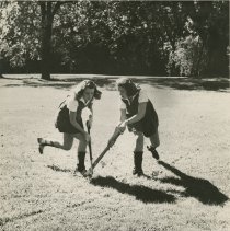 Two Female Students Playing Field hockey, ca. 1960s