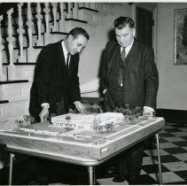 Two Men next to Model of Dorothy Bell Center
