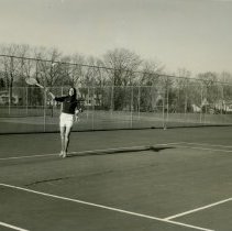 Student playing tennis