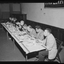 Nine people at banquet table