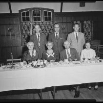 Seven people at banquet table