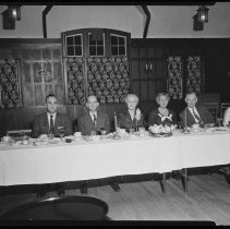 Six people at a banquet table