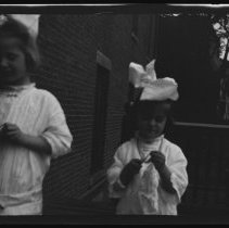 Two girls and a woman on a back porch