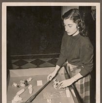 Calliope Bougioukas arranging corn popper, Haverhill Public Library, 1948
