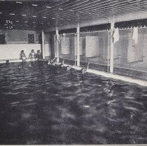 People swim in indoor pool