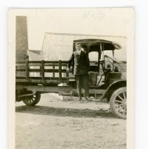 Edward Smart on the step of a truck, 1917